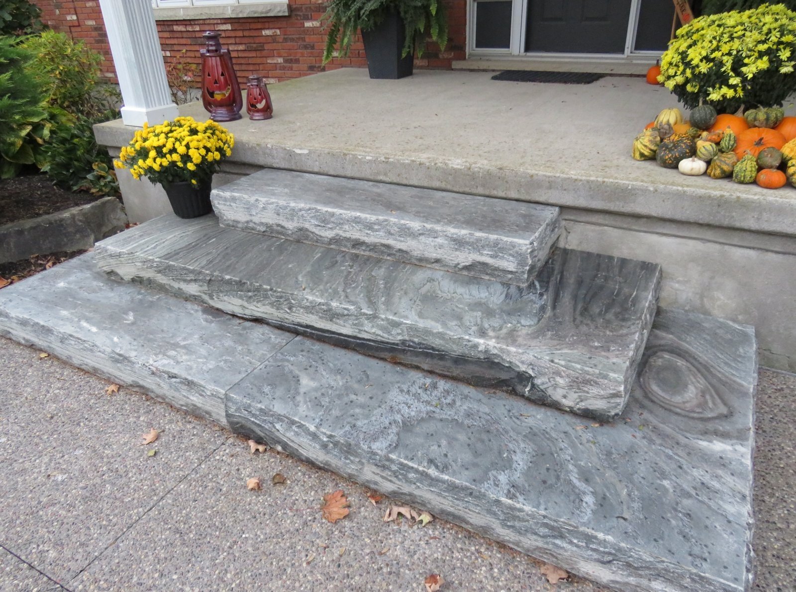 Elite Blue Granite steps with rock-face live edge at brick house front entry