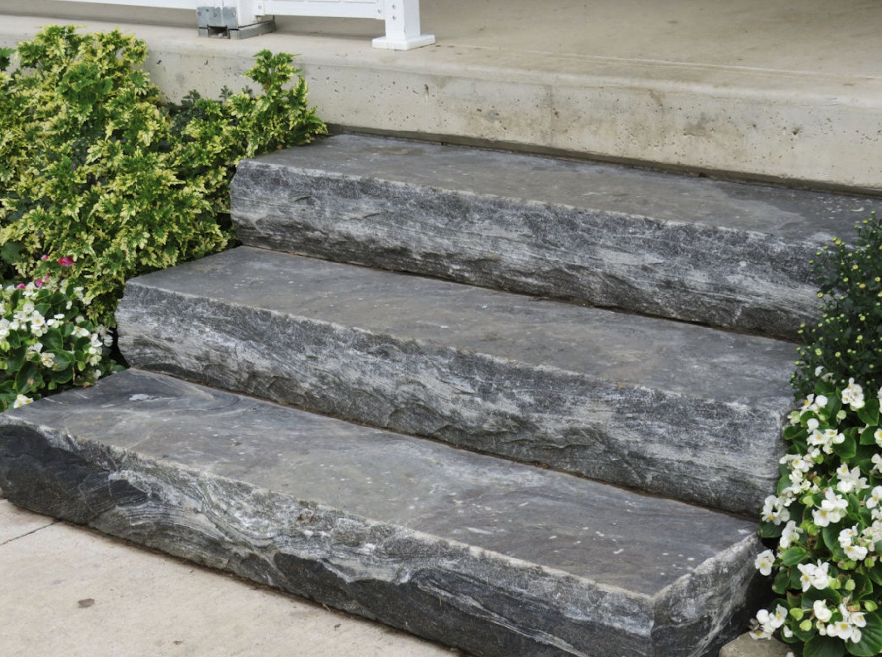 Three Elite Blue Granite natural stone steps with rock-face edge at porch entry