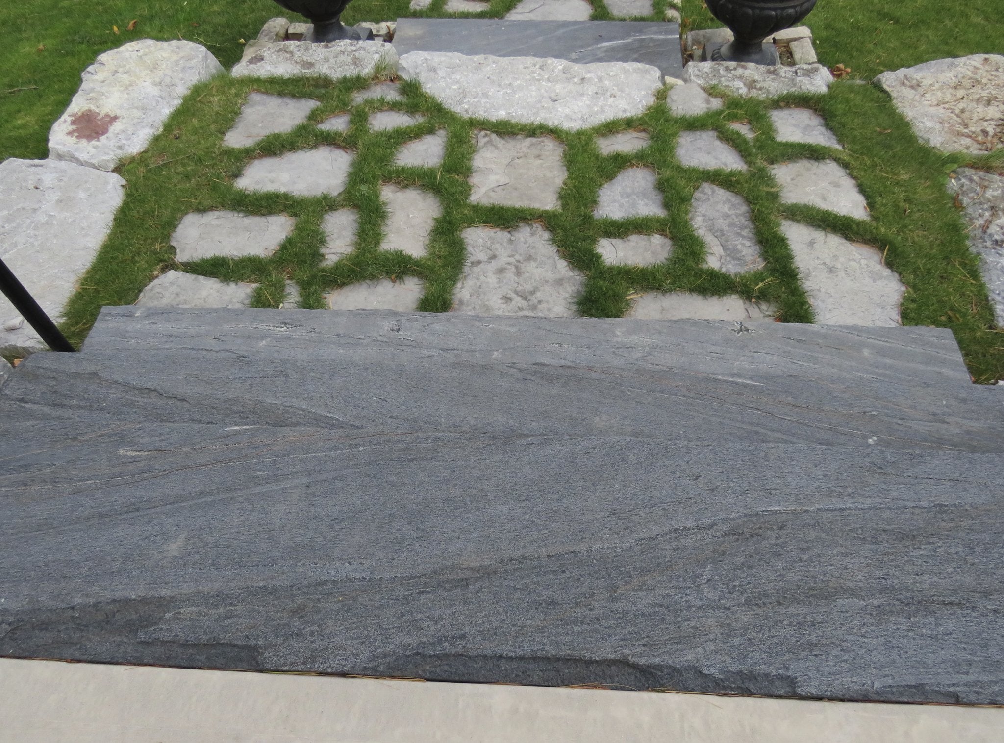 Top-down view of split-top natural stone step showing hand-split rough top face