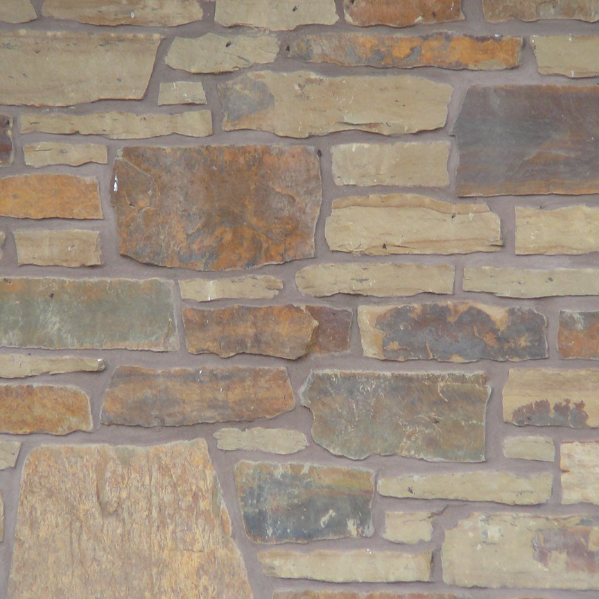Muro de cerco de Peterbourough con revestimiento de piedra fina en tonos tierra de estilo rústico Eden Mills - Flats