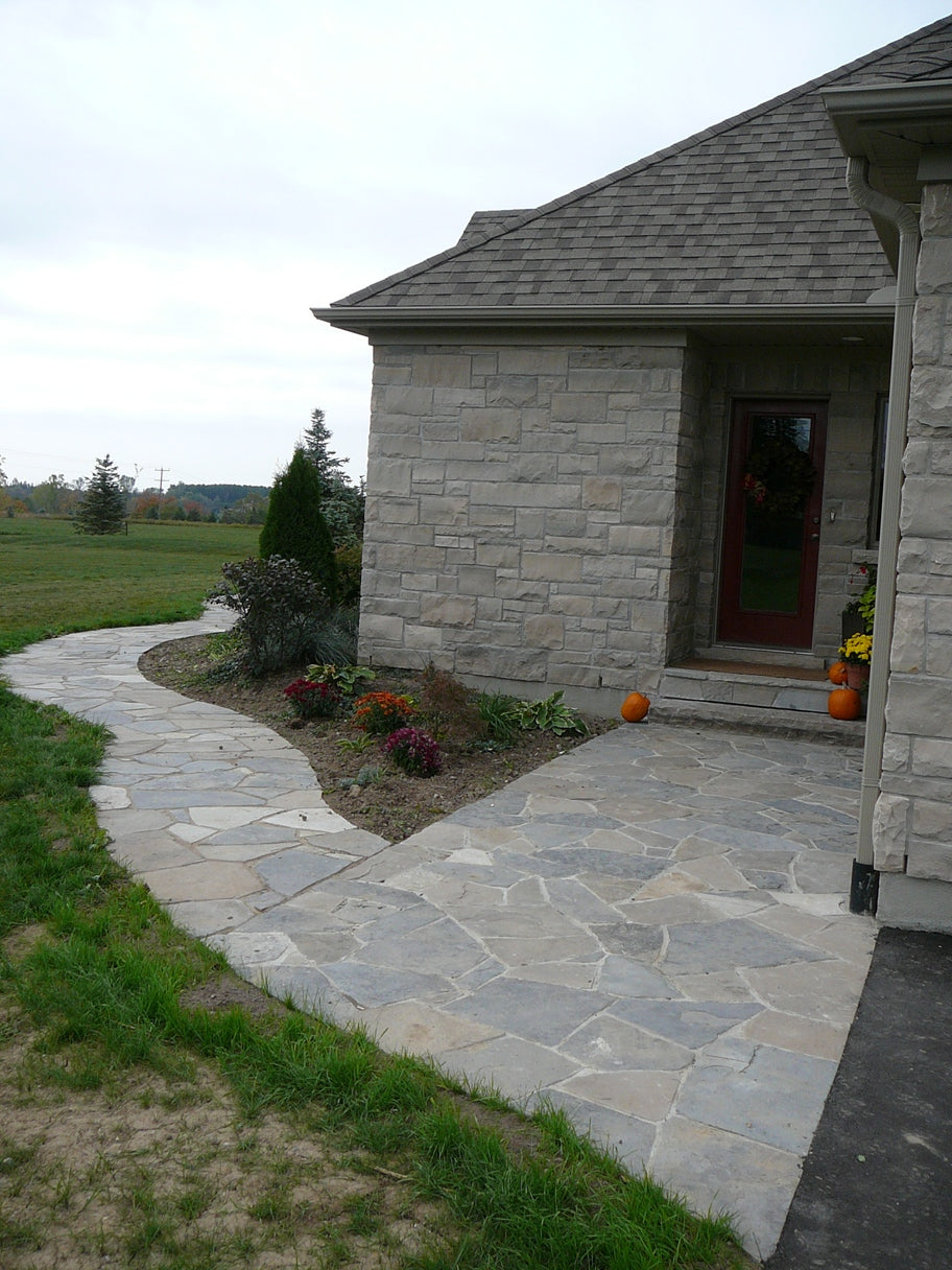 Tumbled limestone garden path flagstone — laid walkway view