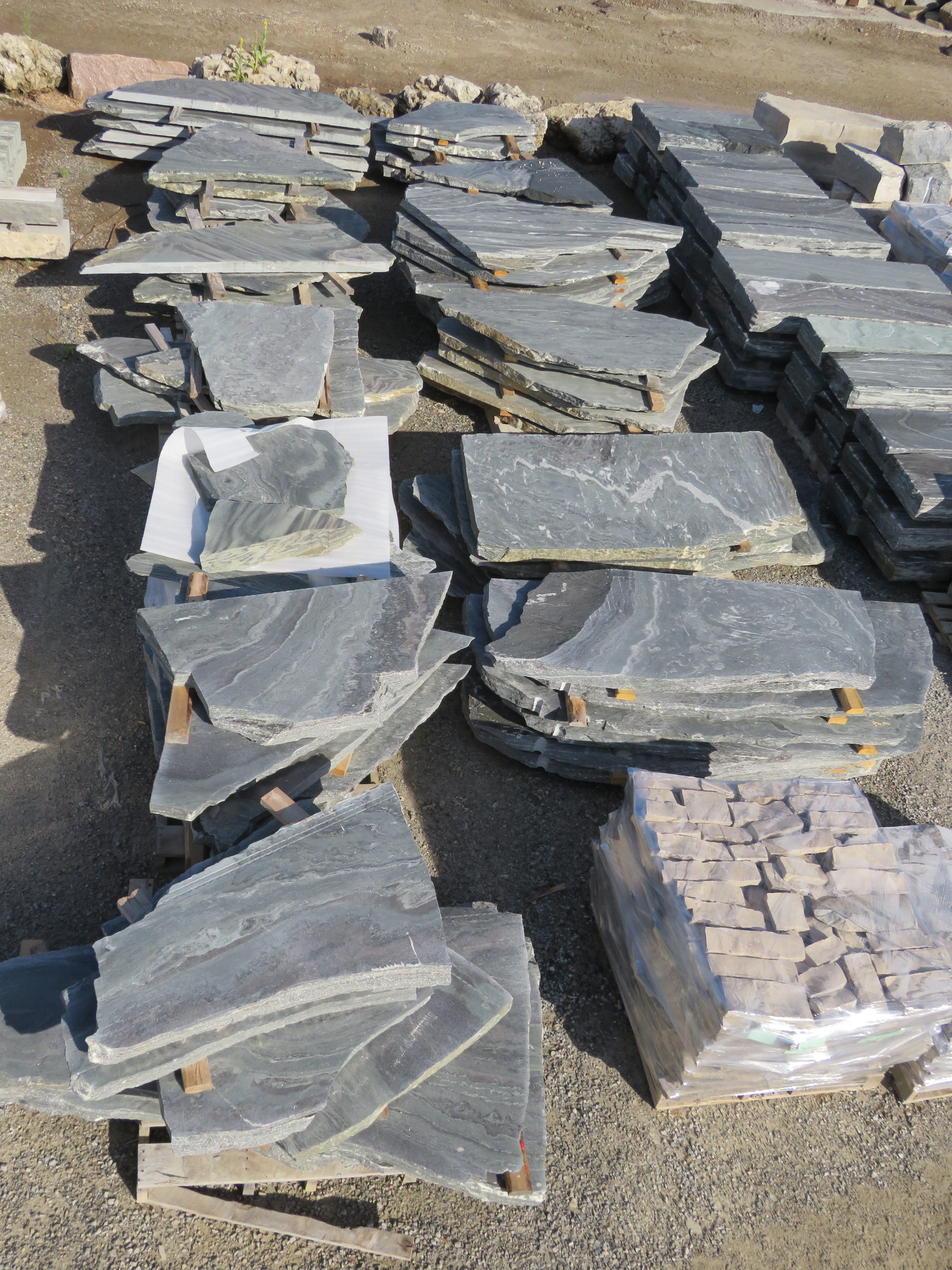 Elite Blue granite tumbled garden path flagstone — stacked pallet detail