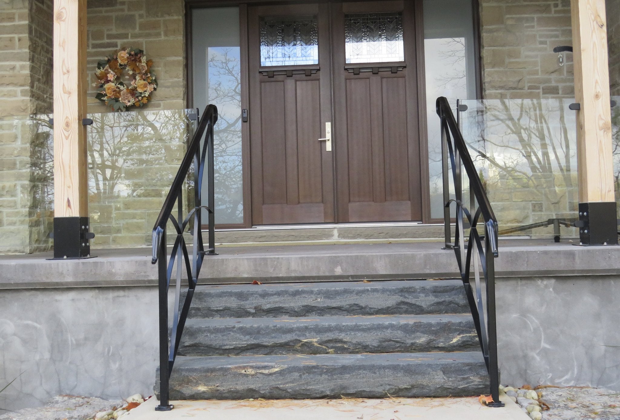 Elite Blue Granite natural stone steps at porch entry with wrought-iron railings