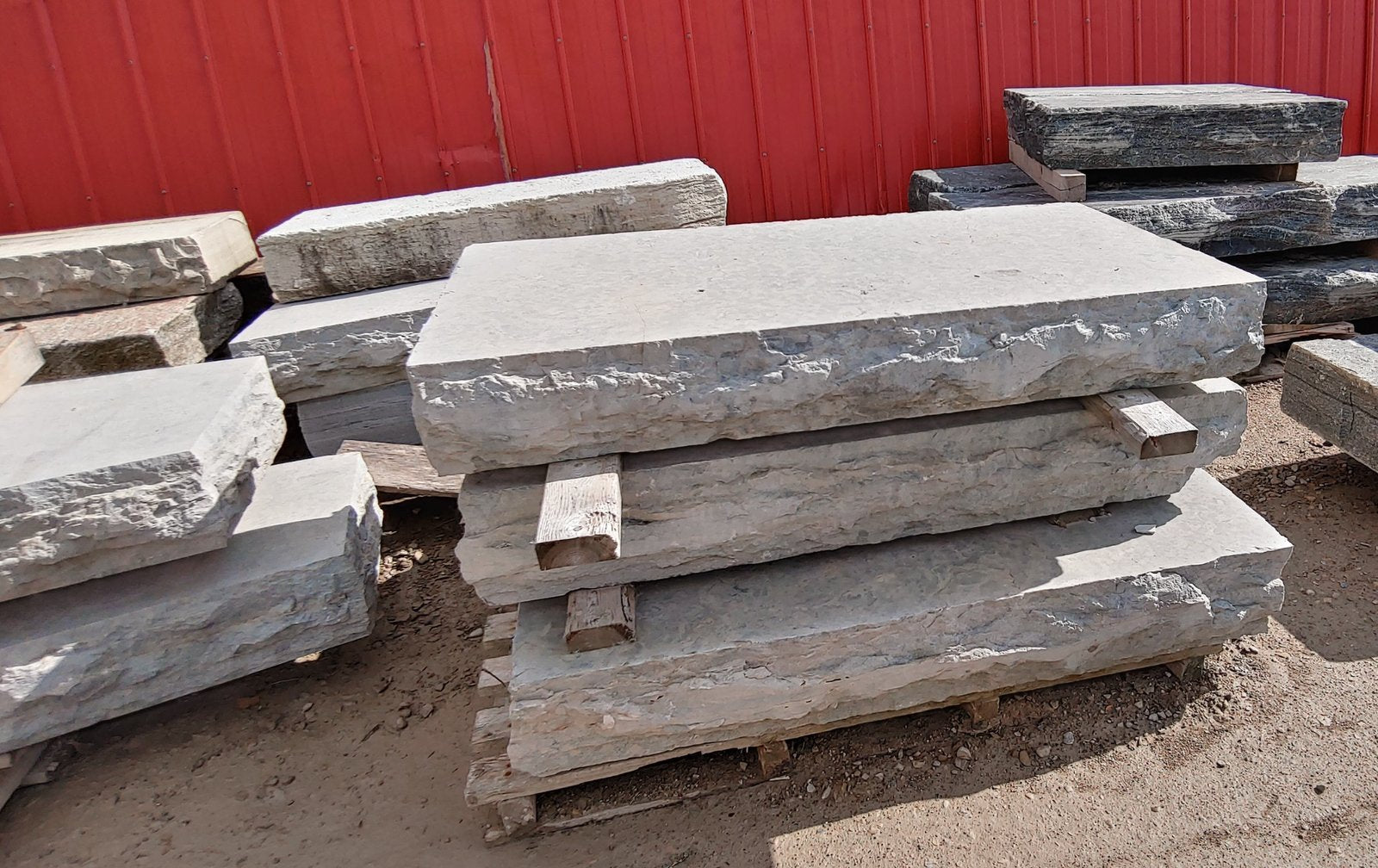 Pallet of Weatheredge Limestone step slabs with rock-face edges in stone yard