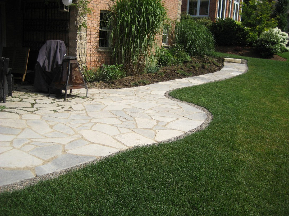 Oversized Tigerstripe limestone flagstone — landscape setting